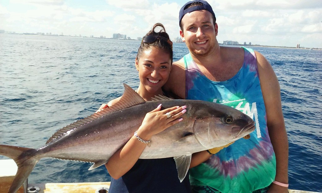 Nice couple holding an amberjack