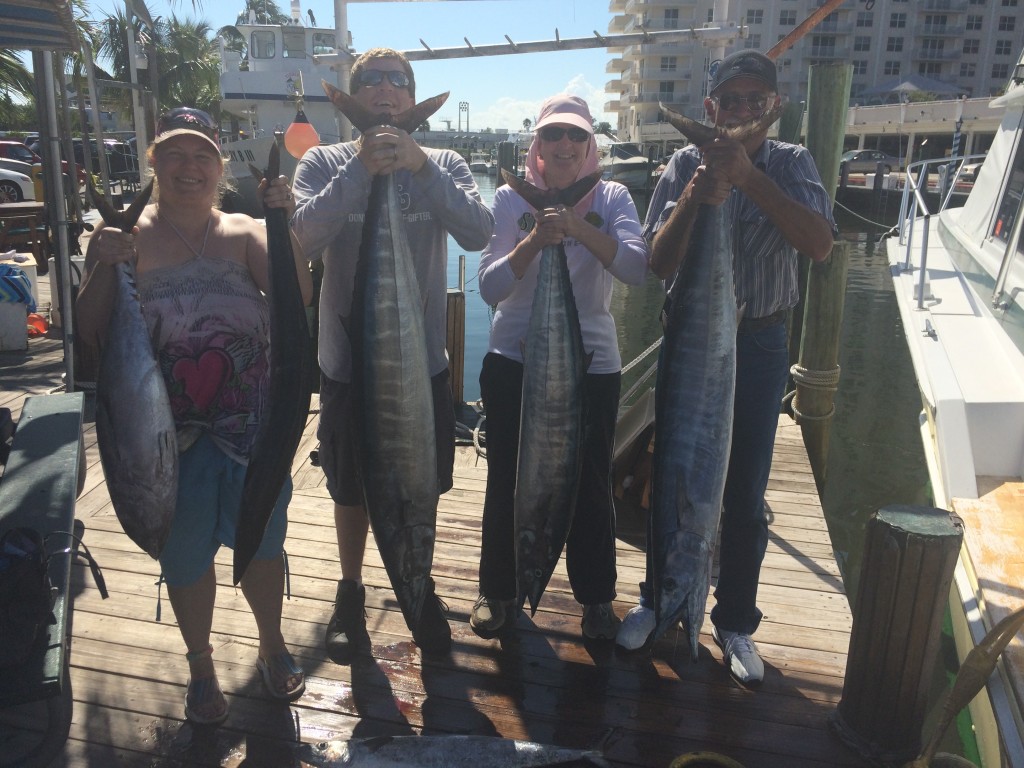 holding the fish at the dock for a picture