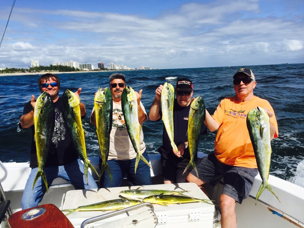 Guys holding up a nice catch of dolphins.