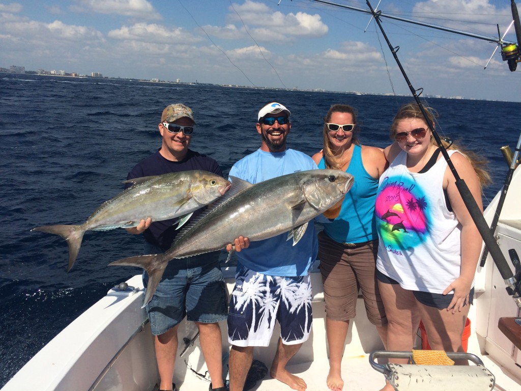 2 jacks in the boat with happy anglers.