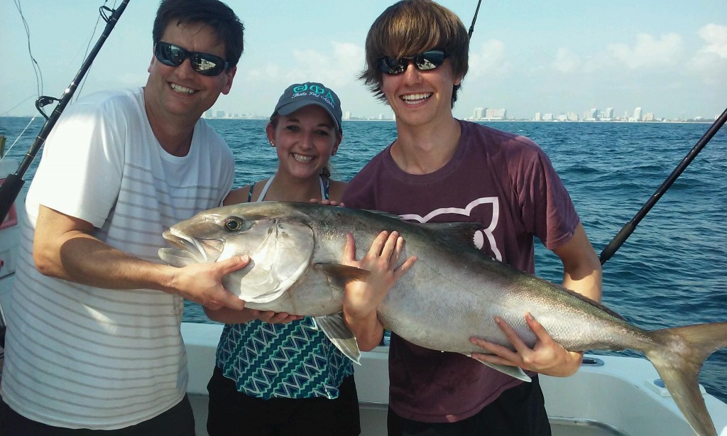 Family holding a nice amberjack