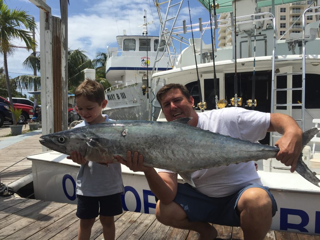 Kid with monster kingfish caught on sportfishing charter