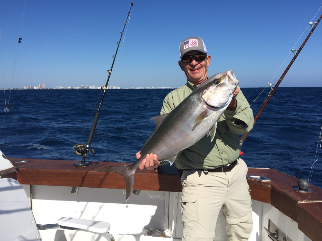 Happy fisherman holding a nice amberjack