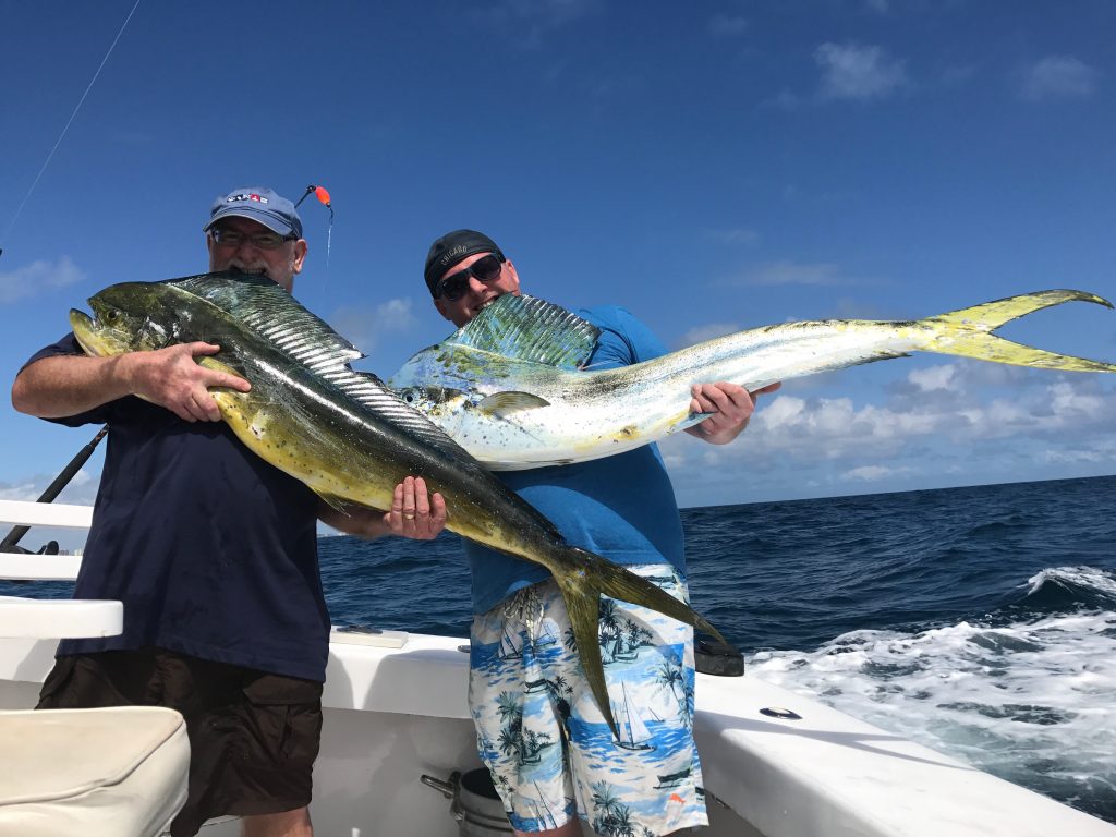 Funny pic of 2 guys biting whole dolphin fish.