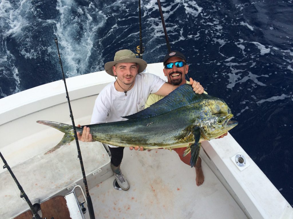 Guys holding a big bull dolphin on our sportfishing charter.
