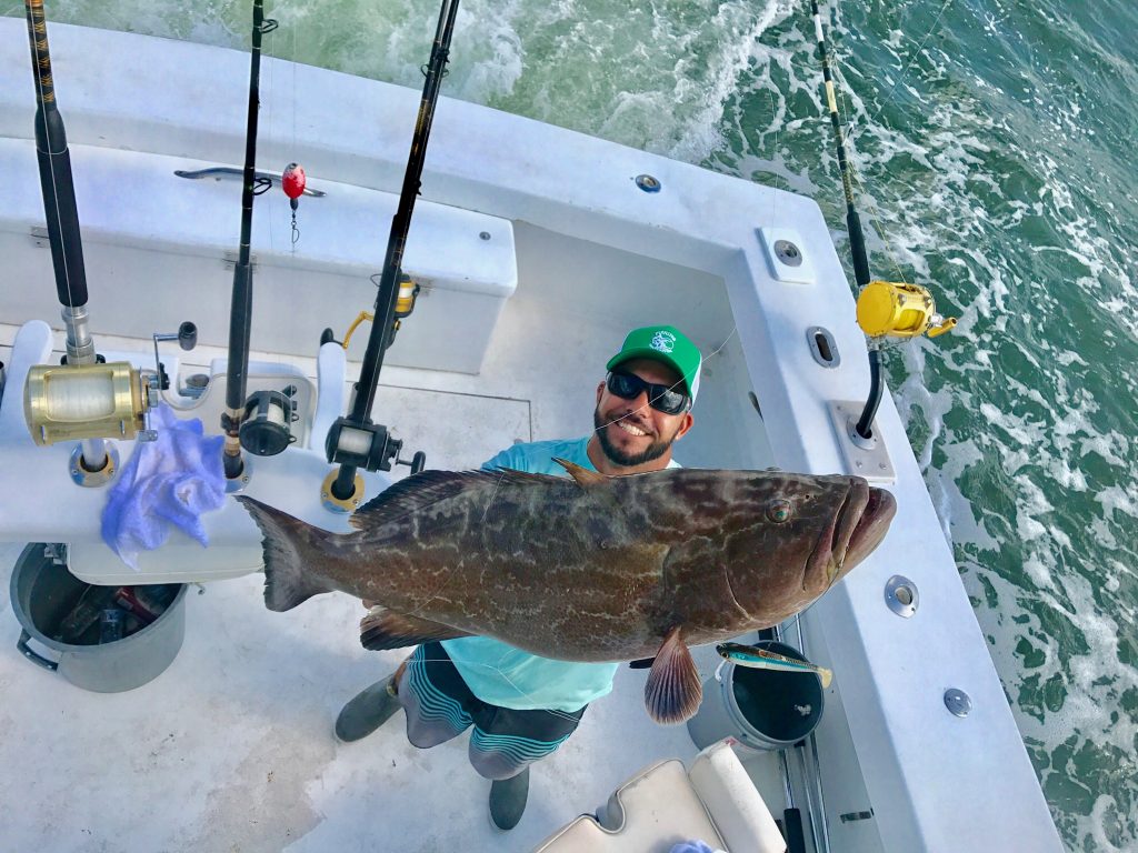 Bobby holding up a big black grouper