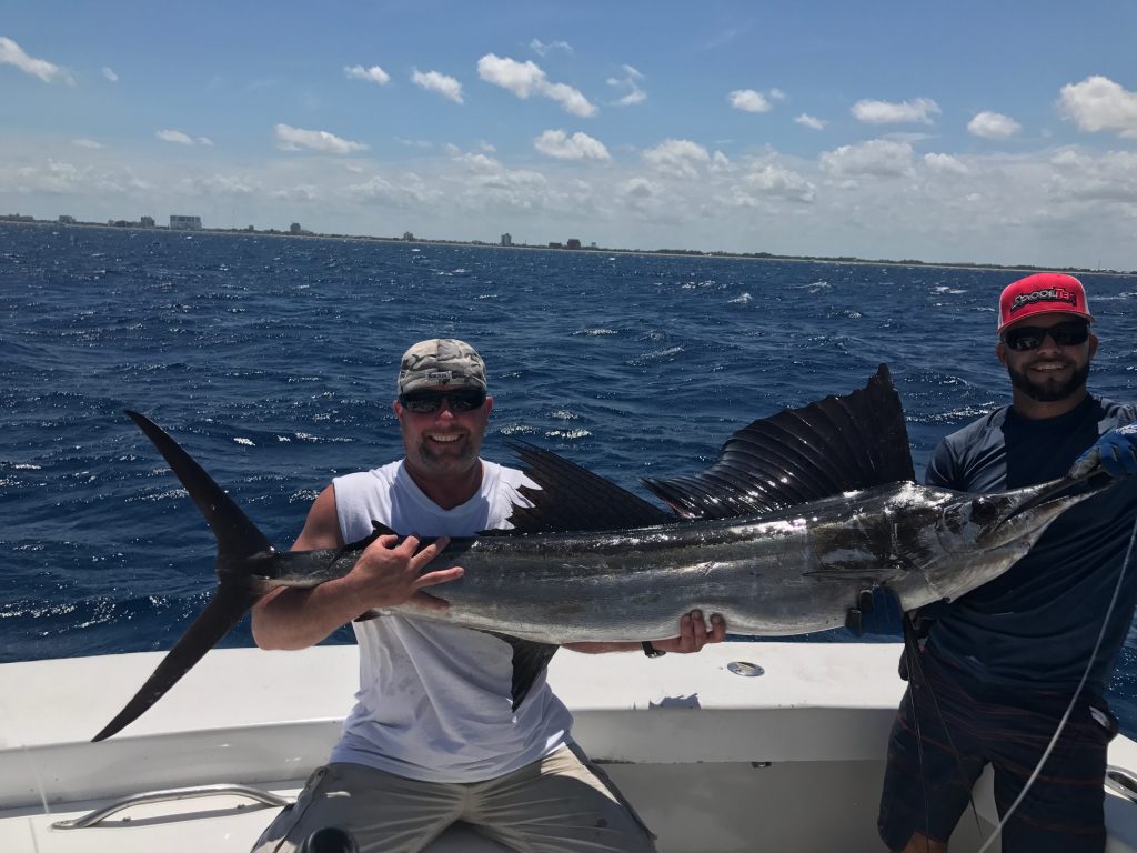 2 guys holding a sailfish just caught off the coast of Fort Lauderdale.