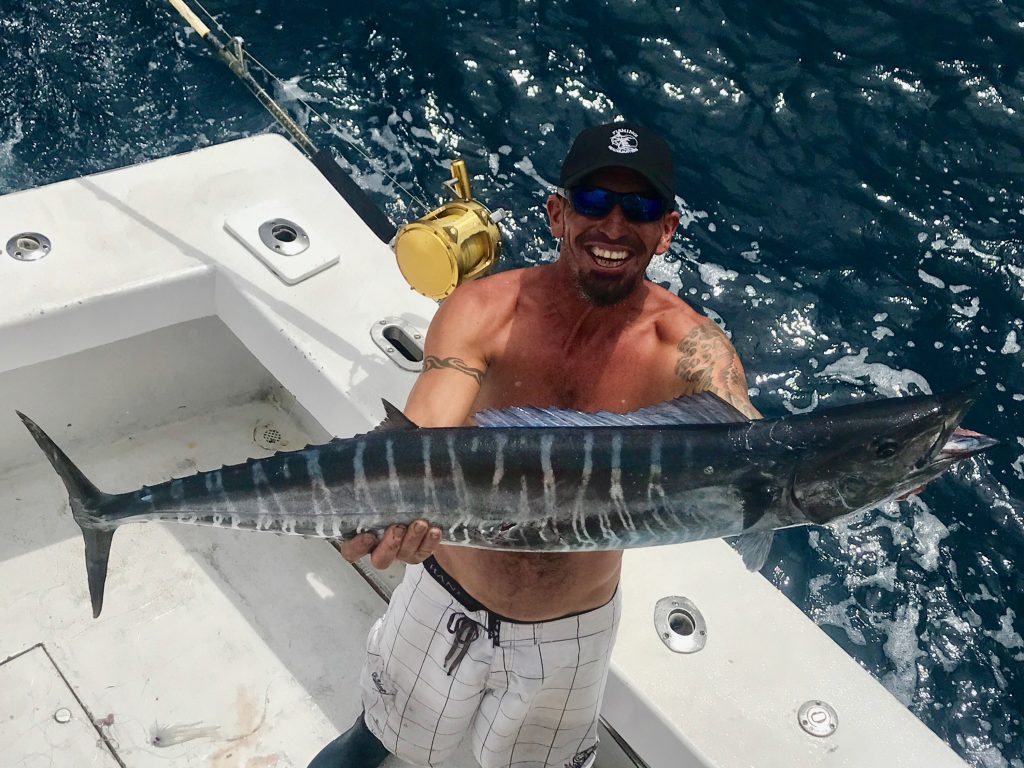 Mick holding a lit up wahoo just caught trolling off Ft Lauderdale