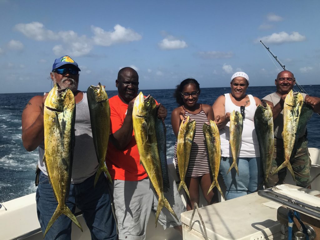 Charter group holding a nice catch of dolphin just caught on our sportfish charter.