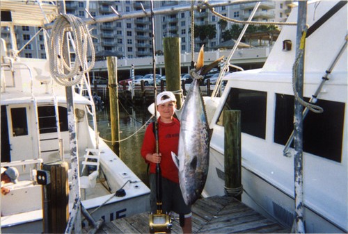 Nice amberjack hanging and the kid who caught him standing next to it.