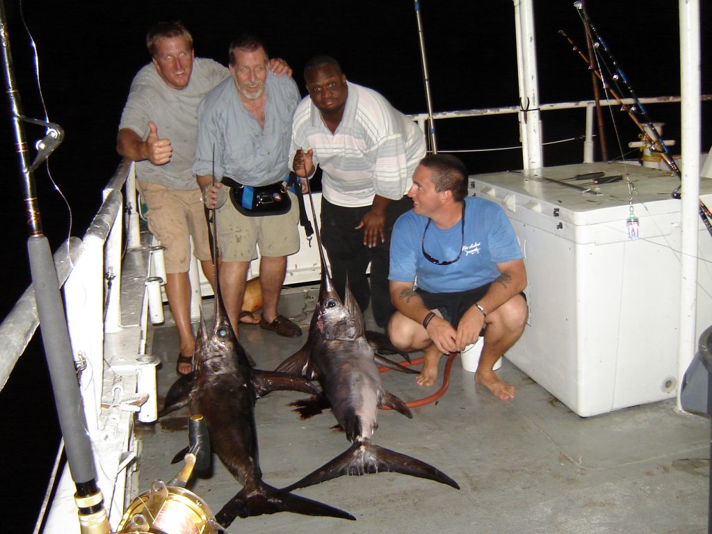 The anglers and crew with the swordfish caught aboard the Catch My Drift