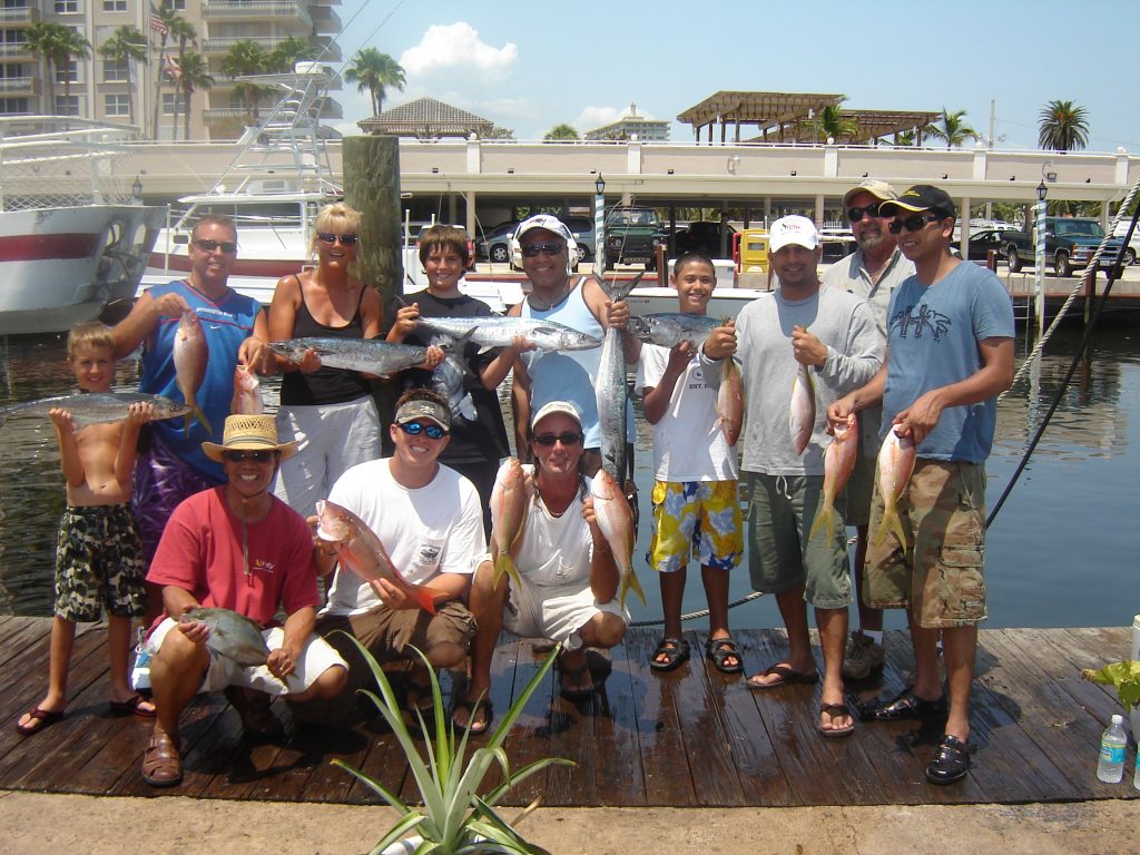 fun folks posing with their catch after the fishing trip