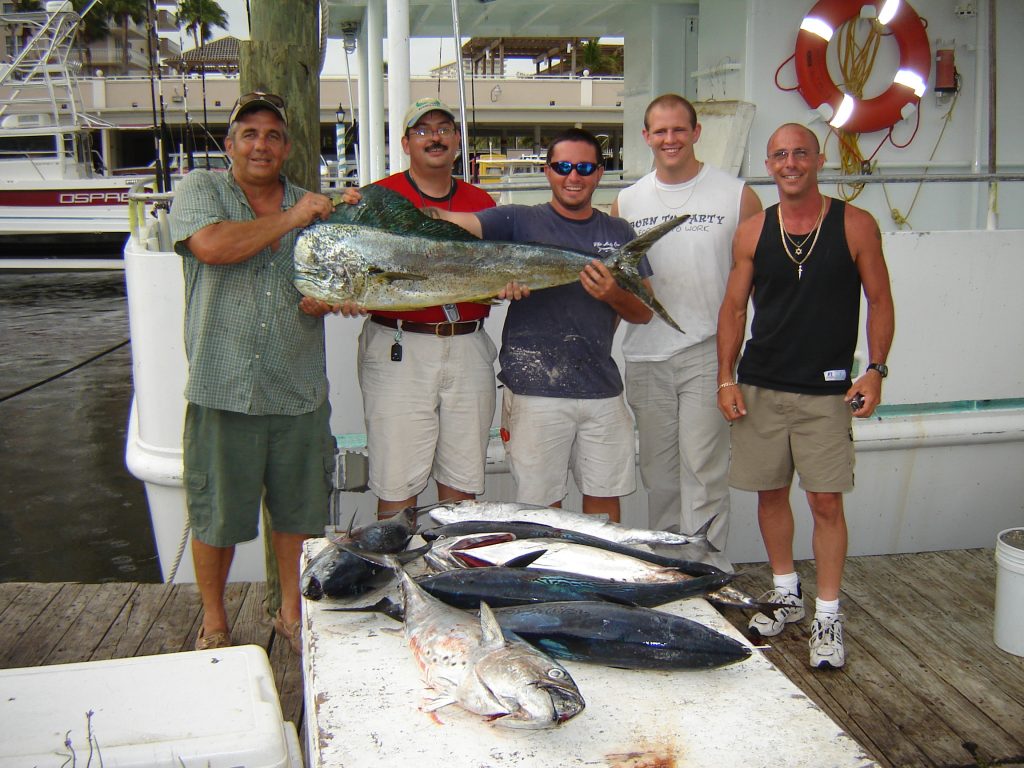 Customers holding up a big dolphin from our dolphin Trip