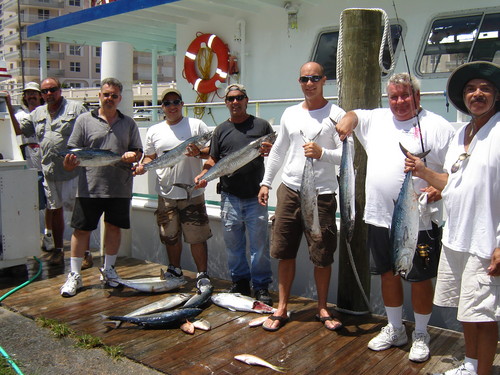 Happy guys holding up a bunch of fish they caught on our drift boat fishing trip.