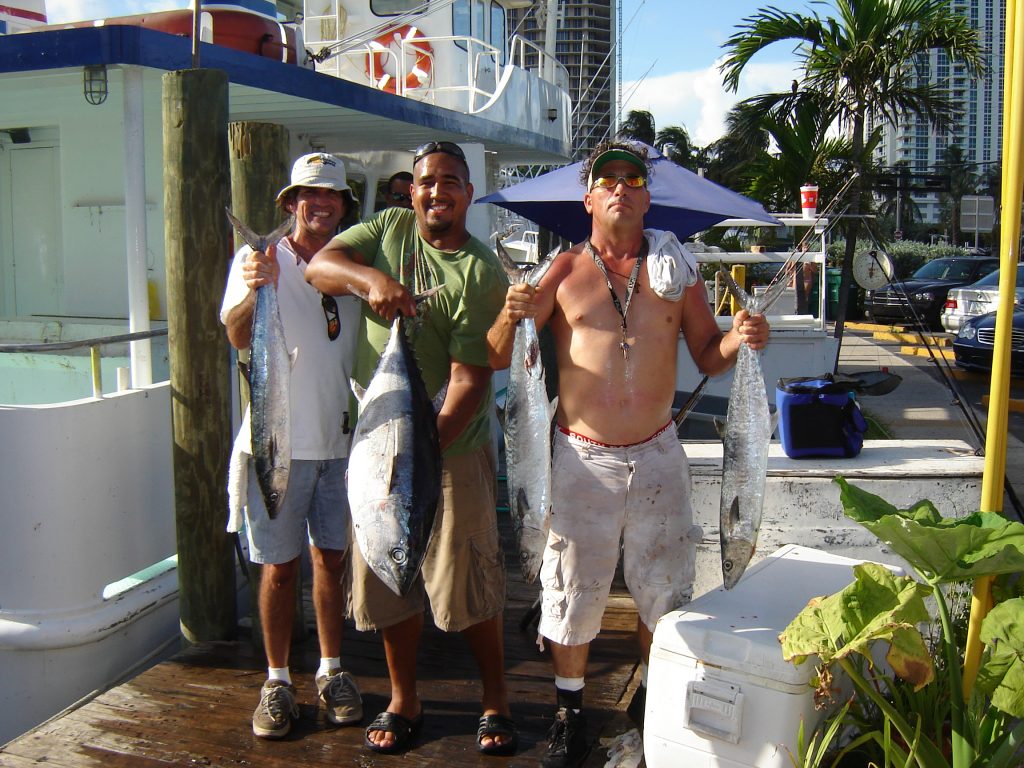 a few guys on our party boat fishing trip holding their fish up.