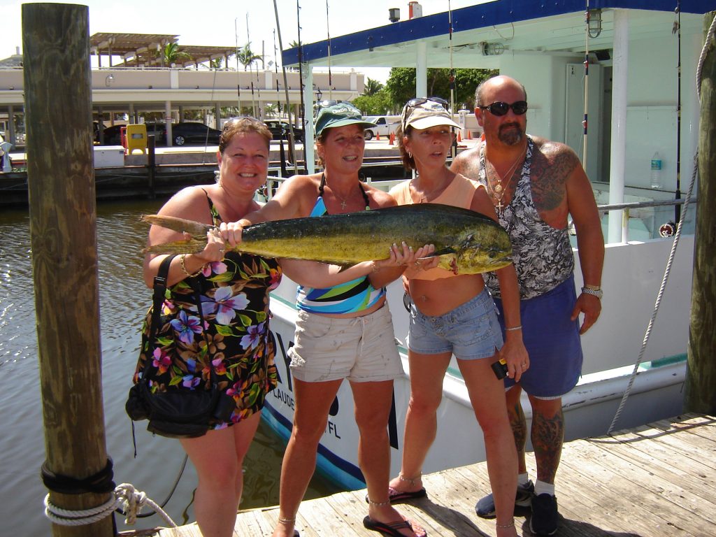 Folks after their drift fishing charter holding their catch