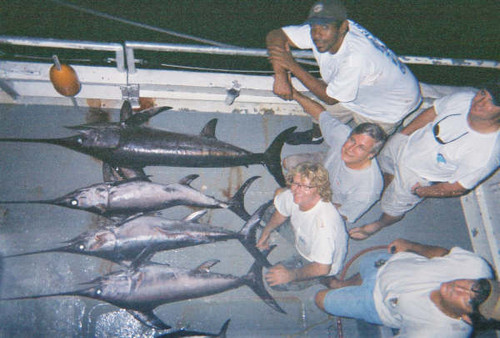 guys taking a pic with the 5 swordfish that we caught on our swordfishing trip