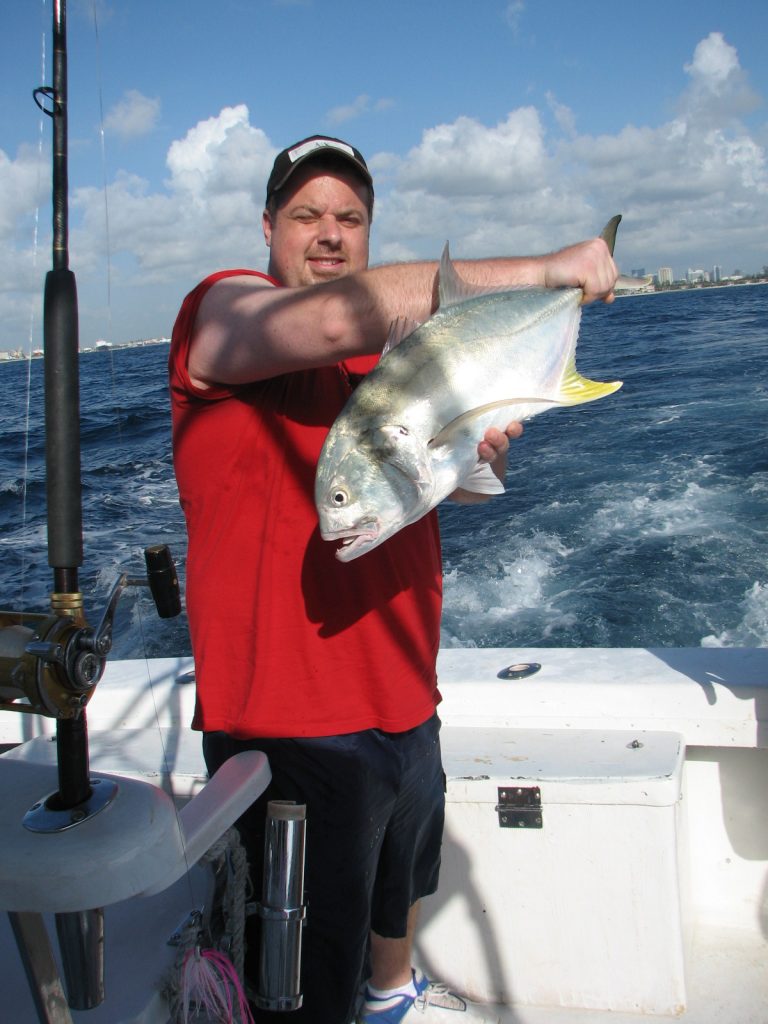 Happy guy with a jack crevale he just caught on our offshore fishing charter