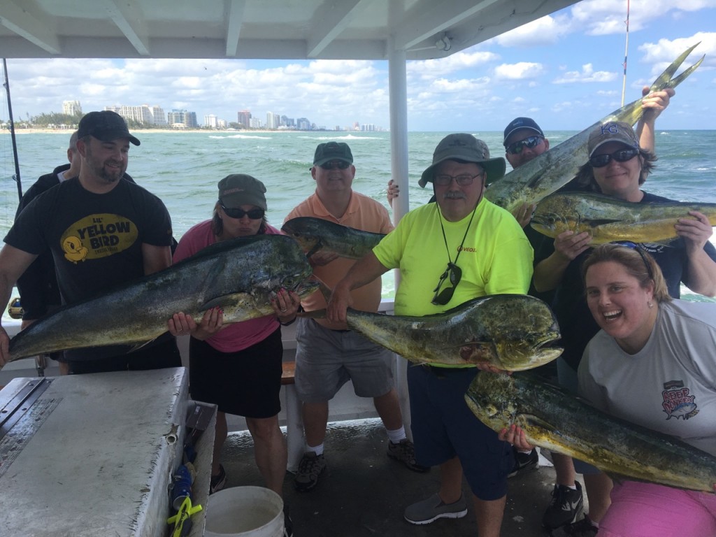 Big family holding a bunch of dolphin on the boat just caught offshore Ft Lauderdale