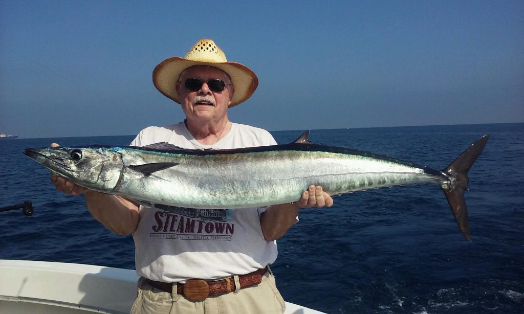 Lucky angler holding a nice wahoo just caught.