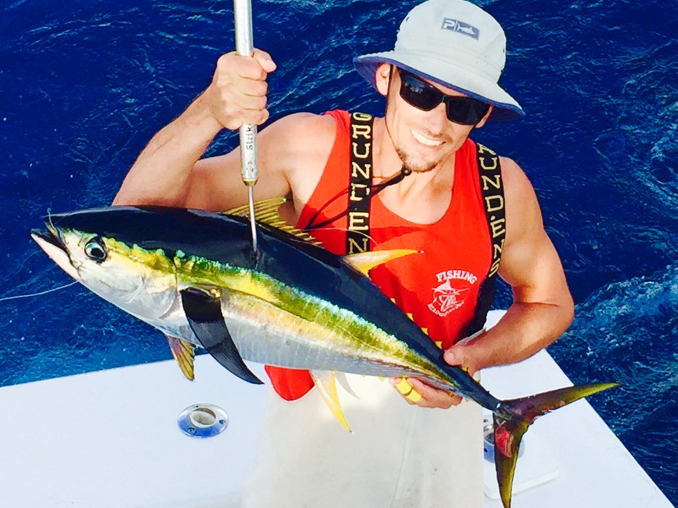 Brett holding an iridescent colored yellowfin tuna.
