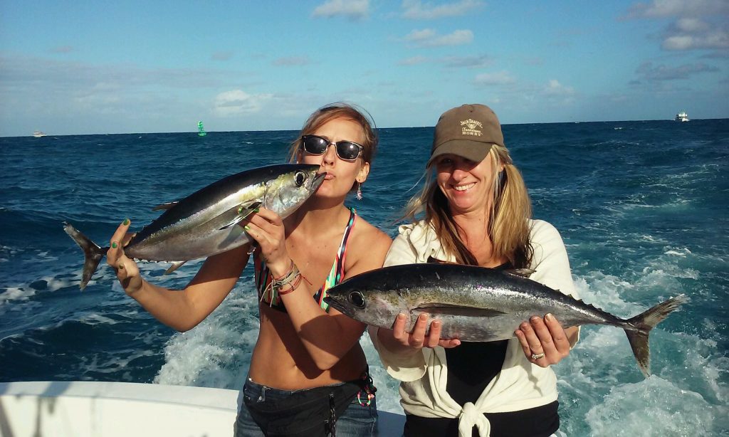 Nice tunas being held by these beautiful fisher girls.