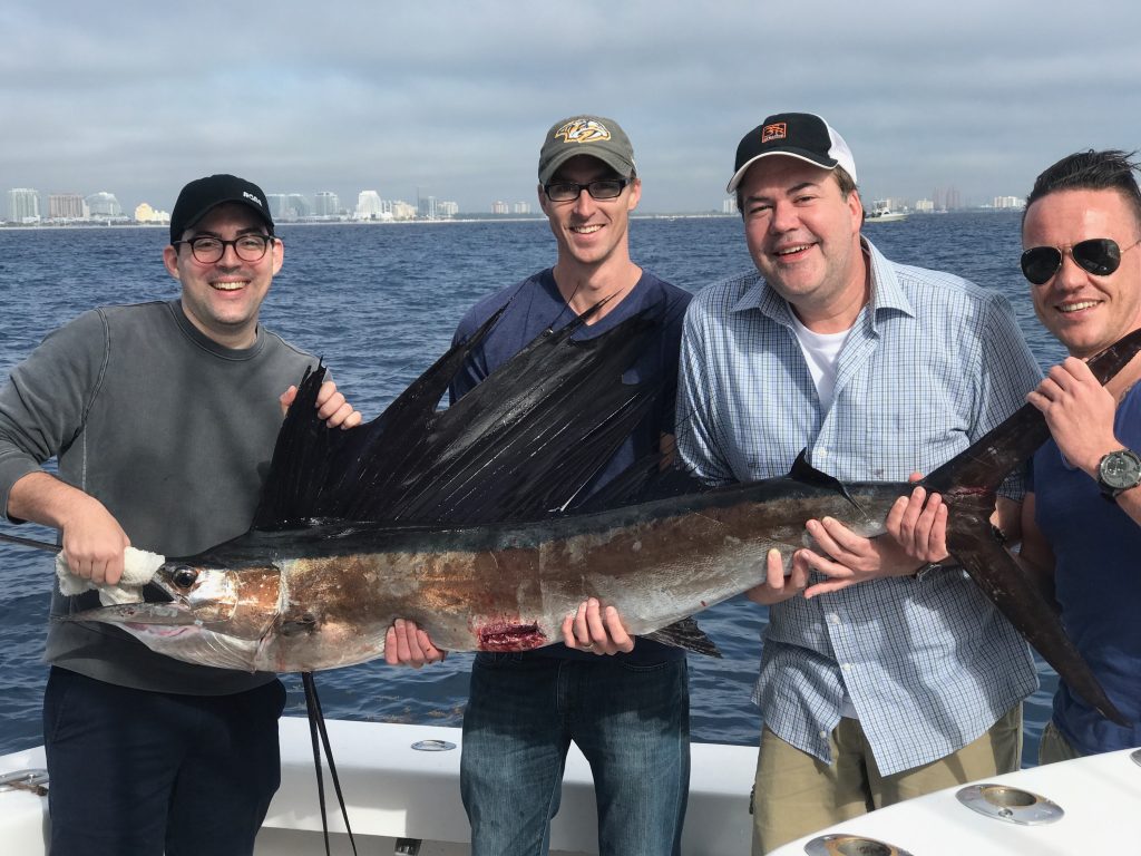 Happy customers with a big sailfish.