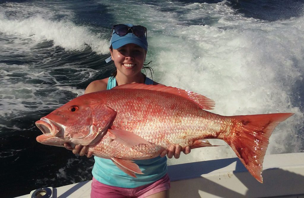 Nice red snapper being held by the girl who caught it.