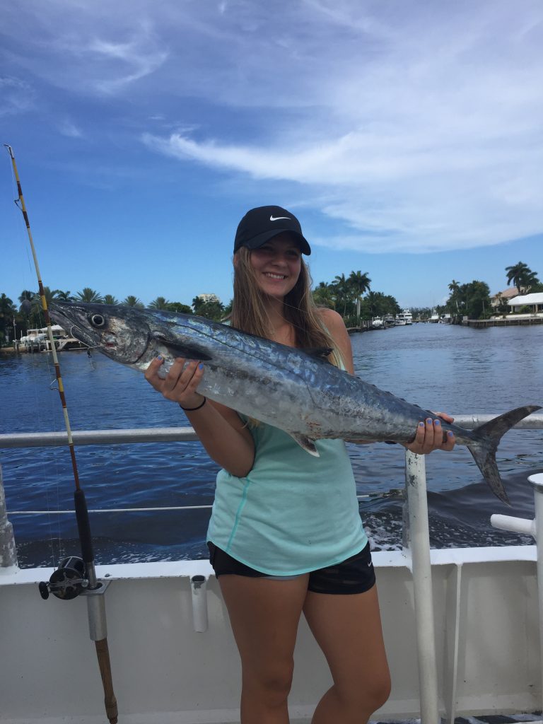 Girl holding a big kingfish aboard the Catch My Drift in the Fort Lauderdale Intracoastal Waterway