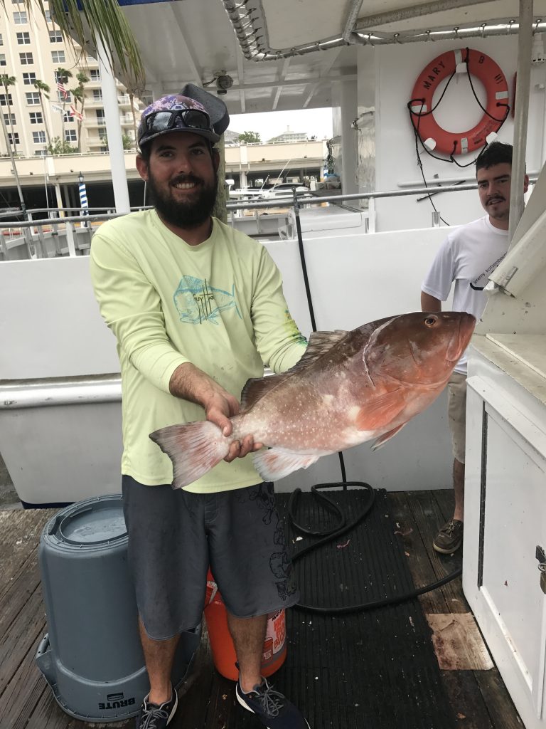 James holding a nice red grouper at the dock
