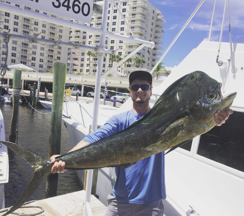 Alex, at the dock, holding another huge mahi-mahi caught on our fishing charter out of Fort Lauderdale.