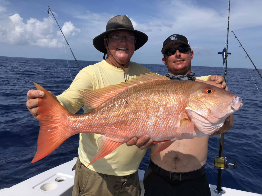 Father and son with a big mutton snapper caught fishing Fort Lauderdale