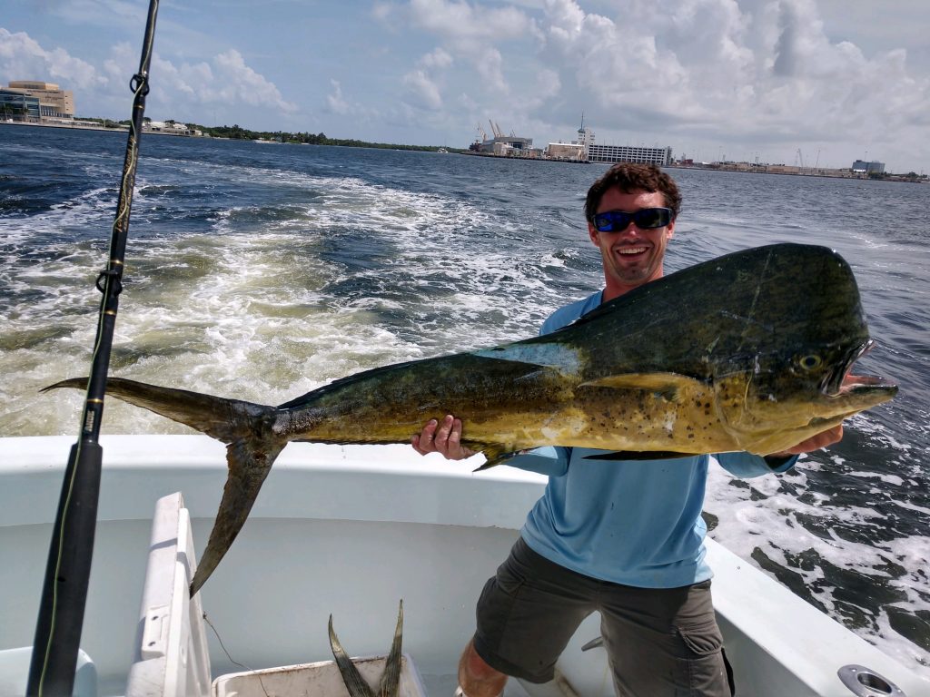 Ryan holding a big mahi-mahi caught on our sportfishing charter.