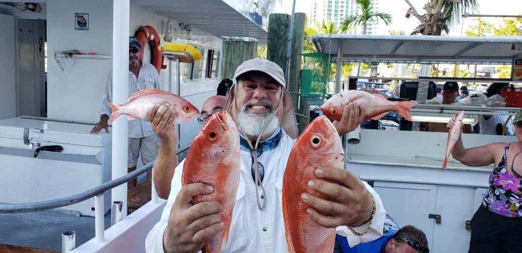 Nice vermillion snapper behind held up at the dock by the lucky angler who caught them.